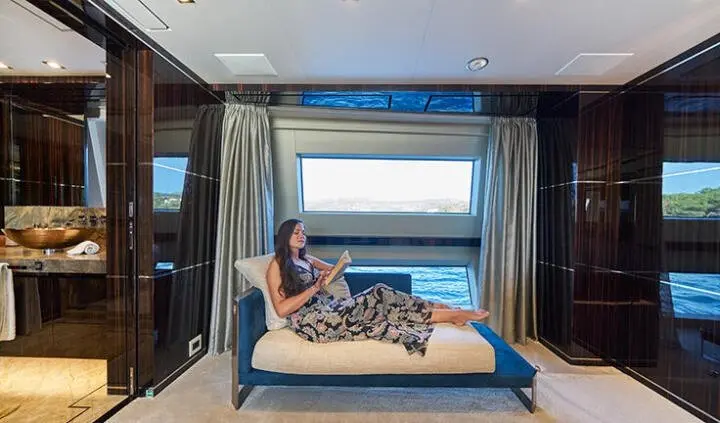 Happy Me yacht cabin with king bed, ensuite, blue accent lighting, large window