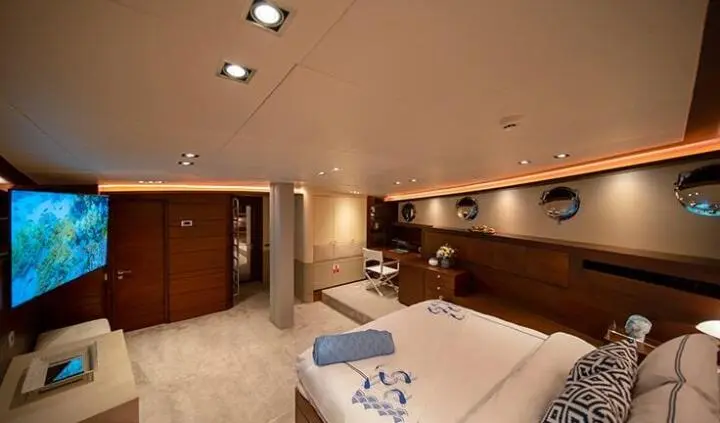 Master cabin with large bed, nightstands, and ensuite door on yacht