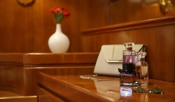 Master cabin with king bed, wood paneling, and white linens on Amoraki yacht