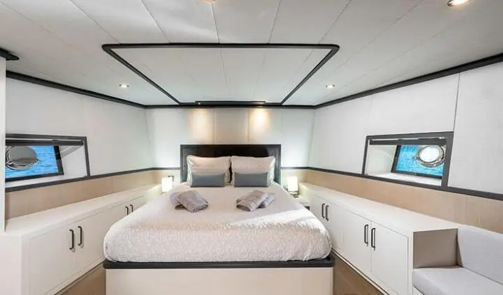 Calm Down yacht cabin with king bed, ensuite visible, neutral tones