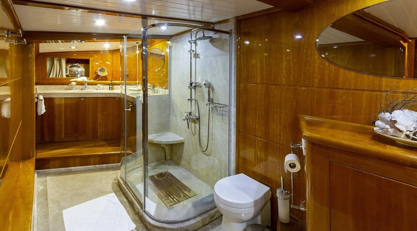Silver Moon gulet bathroom: glass shower enclosure, wooden cabinets, and toilet