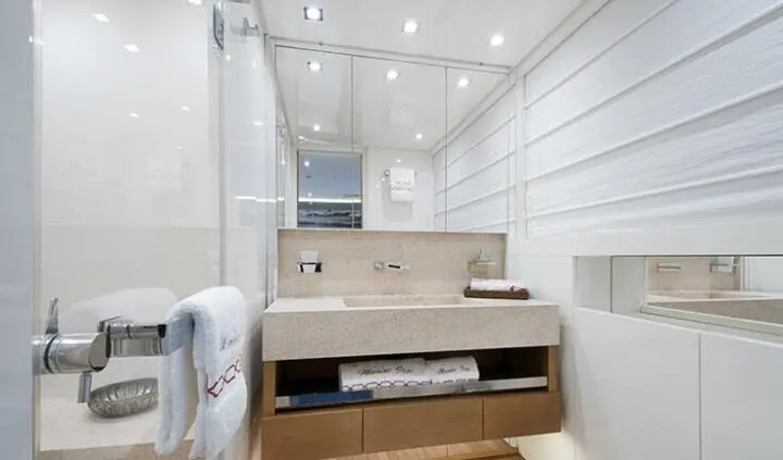 Master cabin with king bed, ensuite vanity, soft lighting and steps