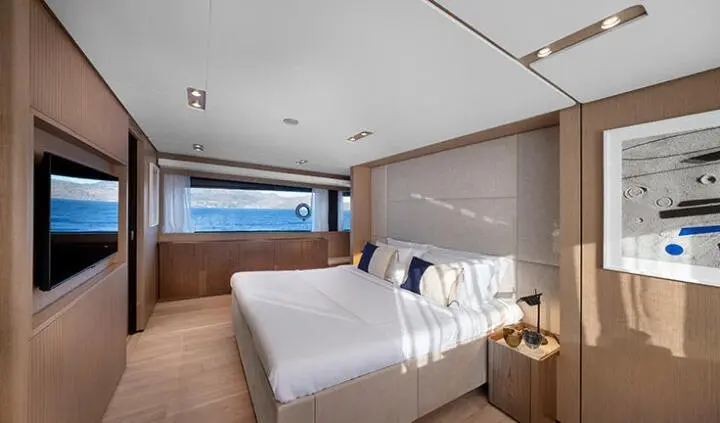 Spica yacht cabin with king bed, ensuite, floating nightstands, window view