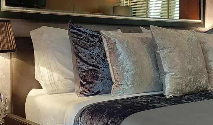 Master cabin with king bed and ensuite on Miraval yacht, plush bedding
