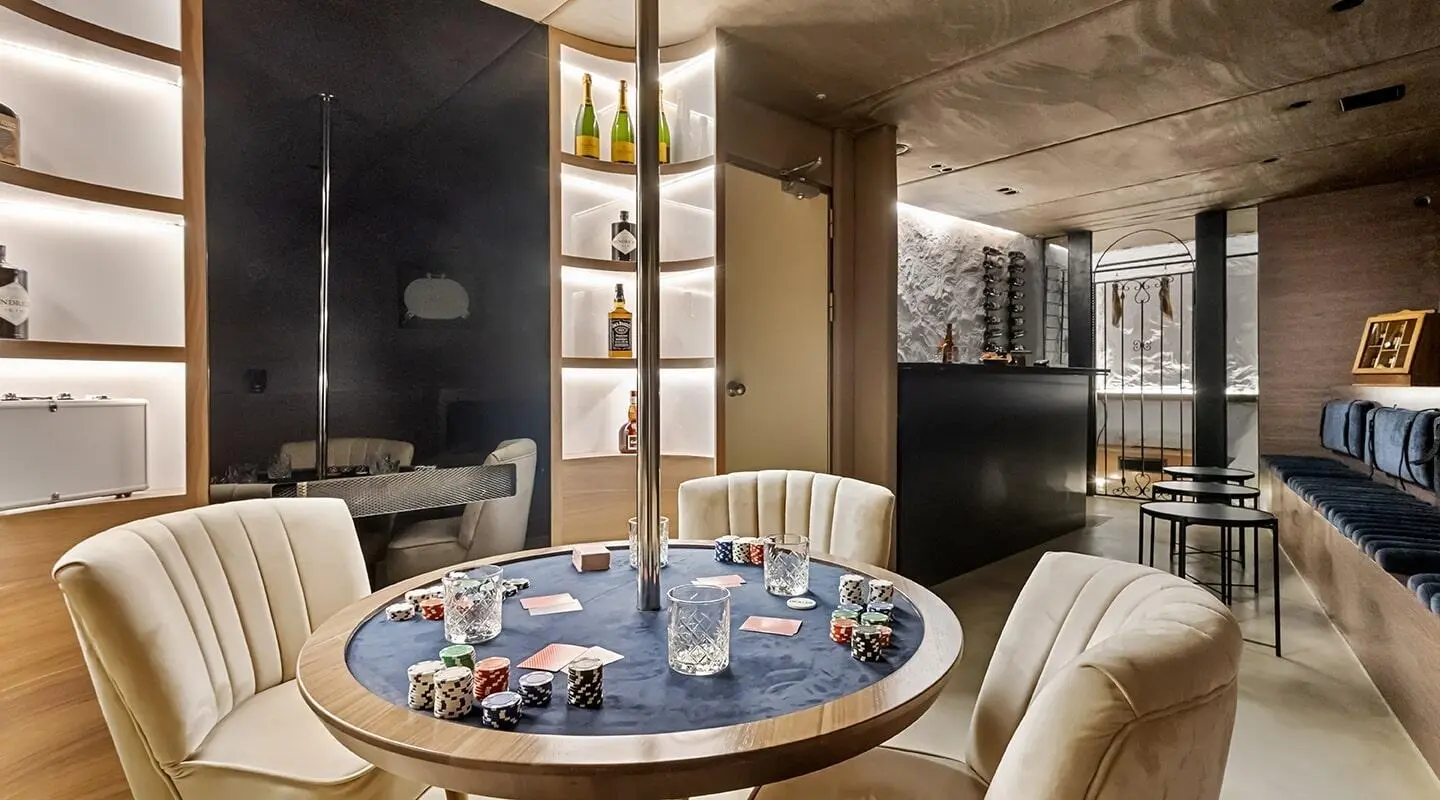 Yacht Bella deck dining area with round table set for guests indoors