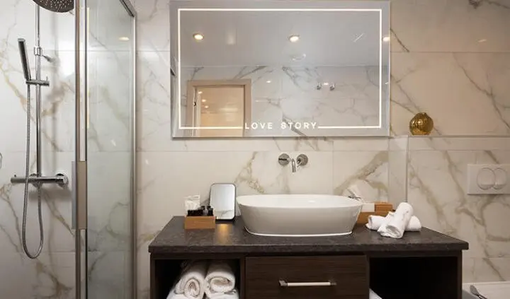 Love Story yacht cabin: modern vanity with sink, mirror, and towels