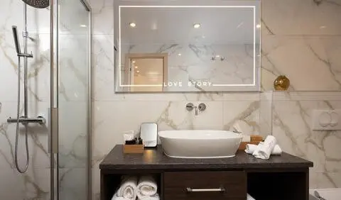 Love Story yacht cabin: modern vanity with sink, mirror, and towels