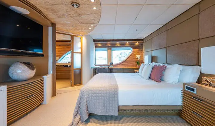 Serenity master cabin with king bed, ensuite, wood cabinetry, porthole