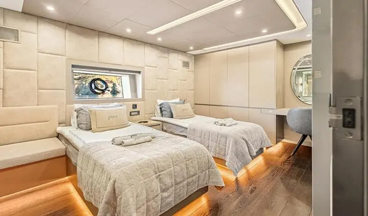 North Wind yacht cabin with two twin beds, ensuite arrangement and neutral decor