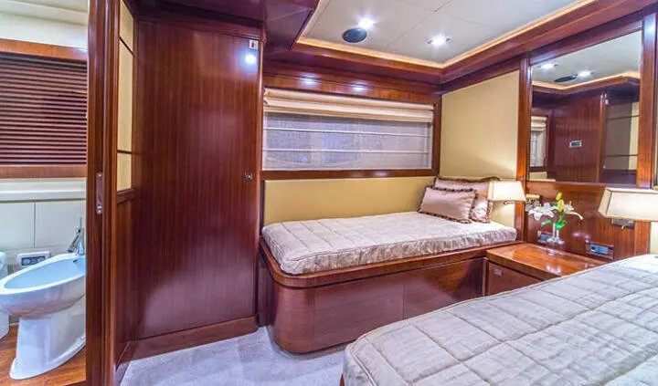 Twin cabin on Seventh Sense yacht: two beds, wood paneling, small window