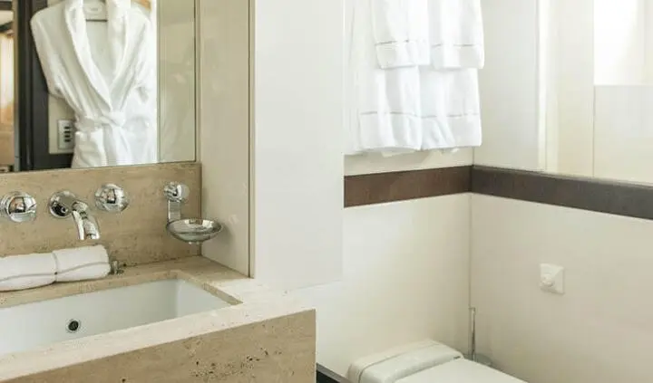 Alalya yacht cabin interior with marble-like vanity, sink, and white towels