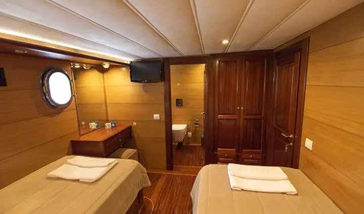 Kayhan 4 yacht twin cabin with ensuite bathroom visible in wood-lined interior