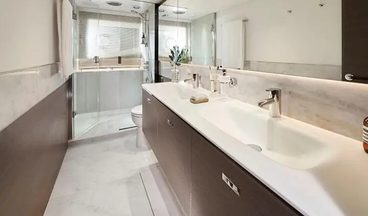 Elizabeth yacht cabin interior with dual-sink vanity and glass shower enclosure
