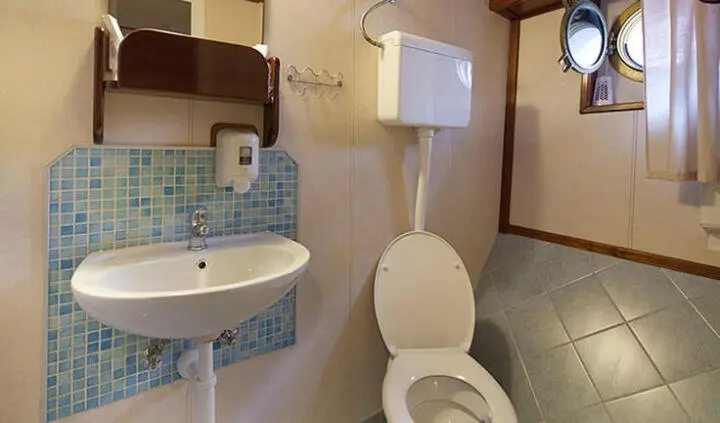 Yacht Tajna Mora cabin with toilet, sink, and window view, compact ensuite