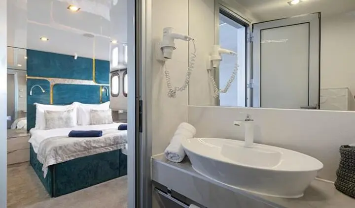 Yacht Yolo master cabin with king bed and ensuite bath visible