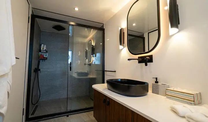 Master cabin with king bed and ensuite vanity sink, modern marina view