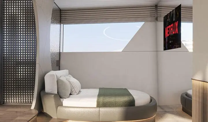 Yacht Bello cabin with circular bed, pillows, and a window view