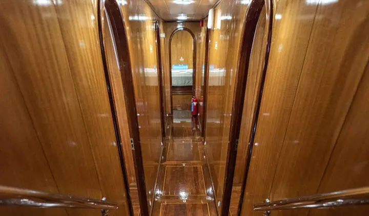 Interior cabin hallway of Kayhan 8 yacht with wooden walls and doors