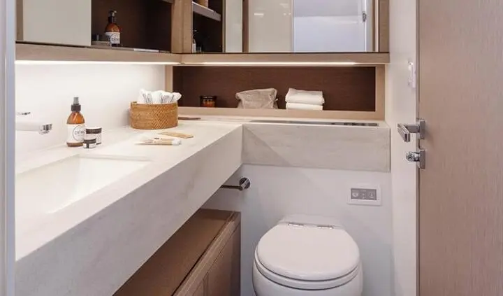 Daiquiri yacht master cabin ensuite bathroom with sink, mirror, toilet