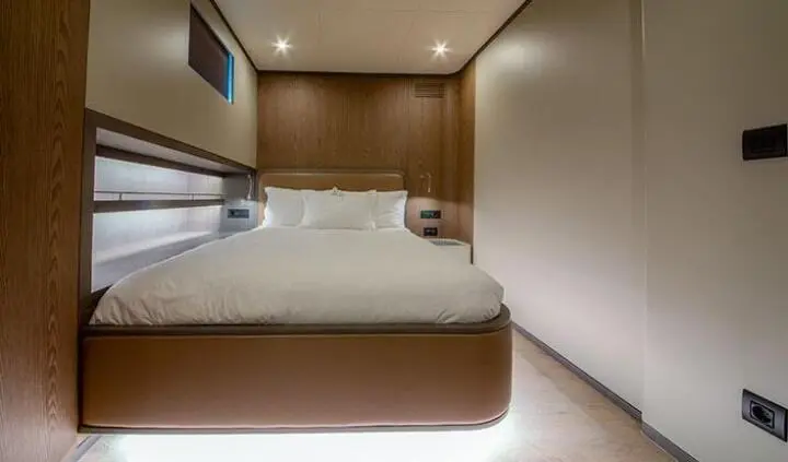 Master cabin with king bed, ensuite bathroom, wood cabinetry, soft lighting