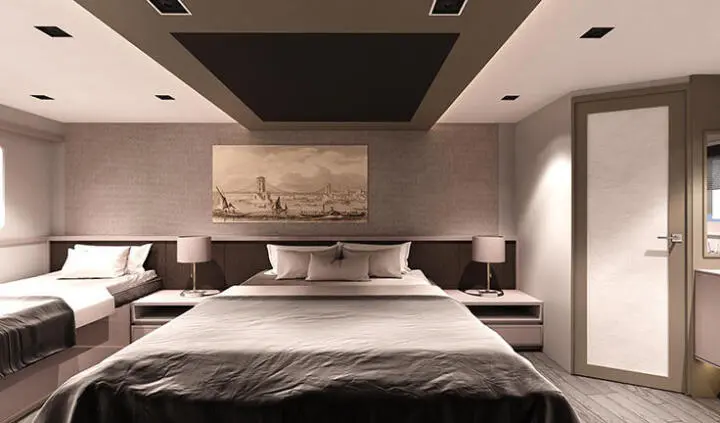 Master cabin with king bed, large padded headboard, bedside lamps