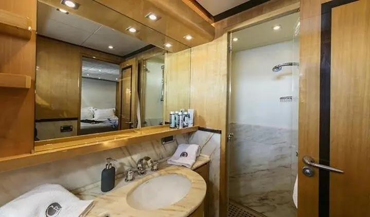 Yacht master cabin with wooden accents, double bed, and ensuite door visible