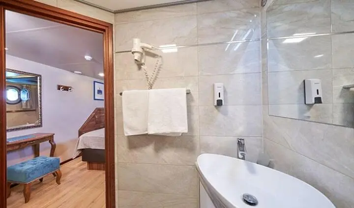Casablanca yacht cabin interior with sink, towel, and marble walls in a luxury suite