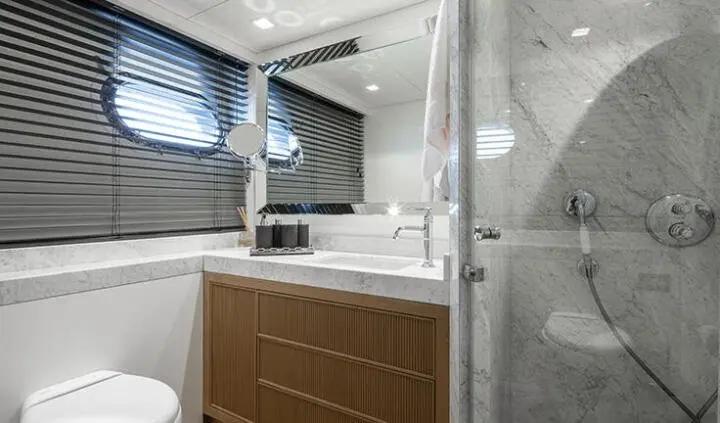 Illusion II cabin with king bed, ensuite, wood cabinet, and porthole window