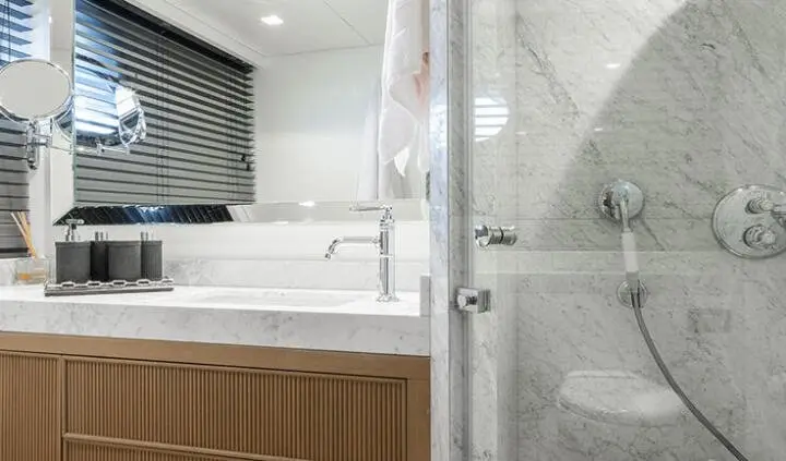 Illusion II cabin bathroom area with glass shower and wooden vanity