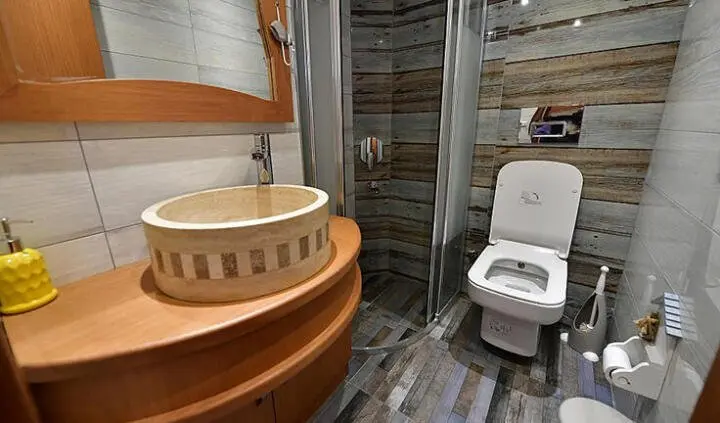 Blu Dream master cabin with a king bed, wood interior, and ensuite door
