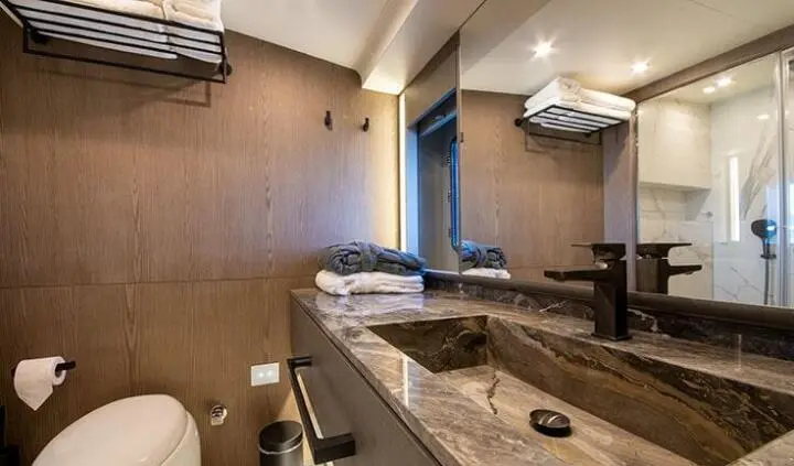 Master cabin with king bed, ensuite visible, wood tones and vanity