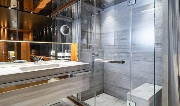 Takara One master cabin with king bed, ensuite shower in glass-walled bathroom