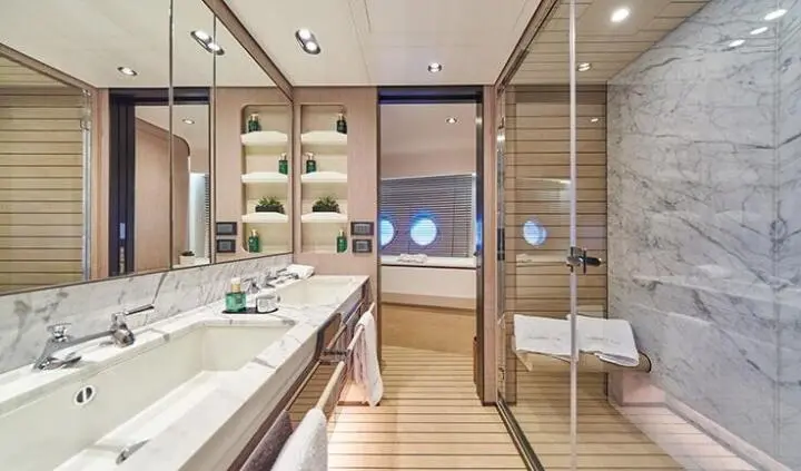 Interior of Aluminia Too cabin showing sink, mirror, wood panels and storage.