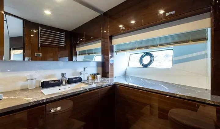 Vista cabin interior aboard yacht with wood cabinetry and large window view