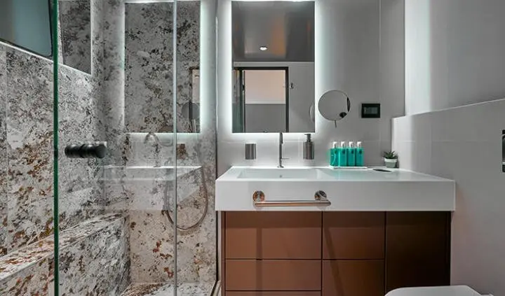 Master cabin with king bed, ensuite bath, dark wood cabinetry and marble walls