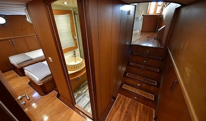 Blu Dream cabin interior with wooden panels, stairs, and doorway scene