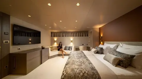 Interior of Nocturno luxury yacht showroom-style lounge with seating and rug