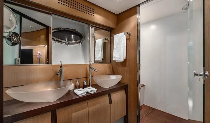 Master cabin with king bed, ensuite area, wood cabinetry, and window.