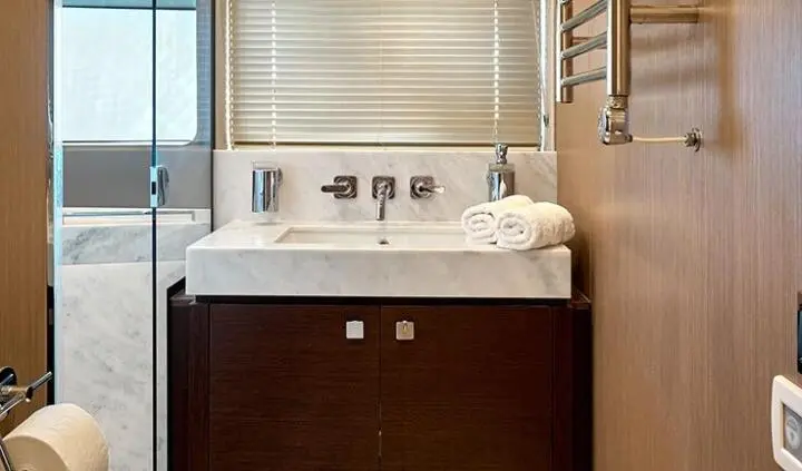Master cabin with king bed, ensuite, dark wood vanity and sink area