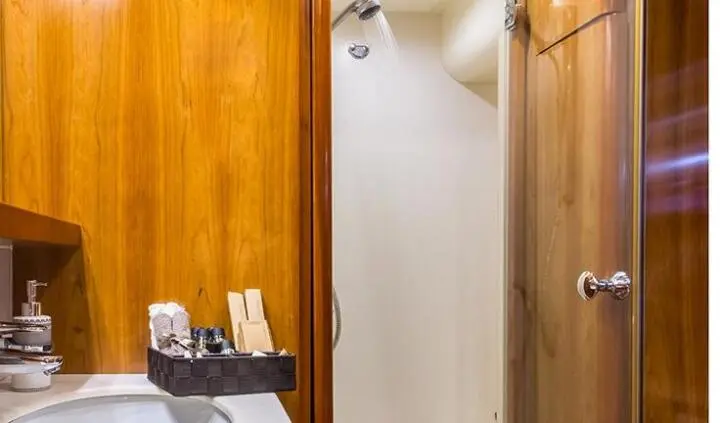 A compact cabin hallway on Amoraki yacht with wooden panels and a door at the end