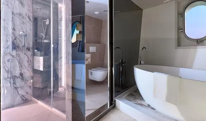 Cristal yacht cabin interior with marble shower, glass enclosure, and freestanding tub
