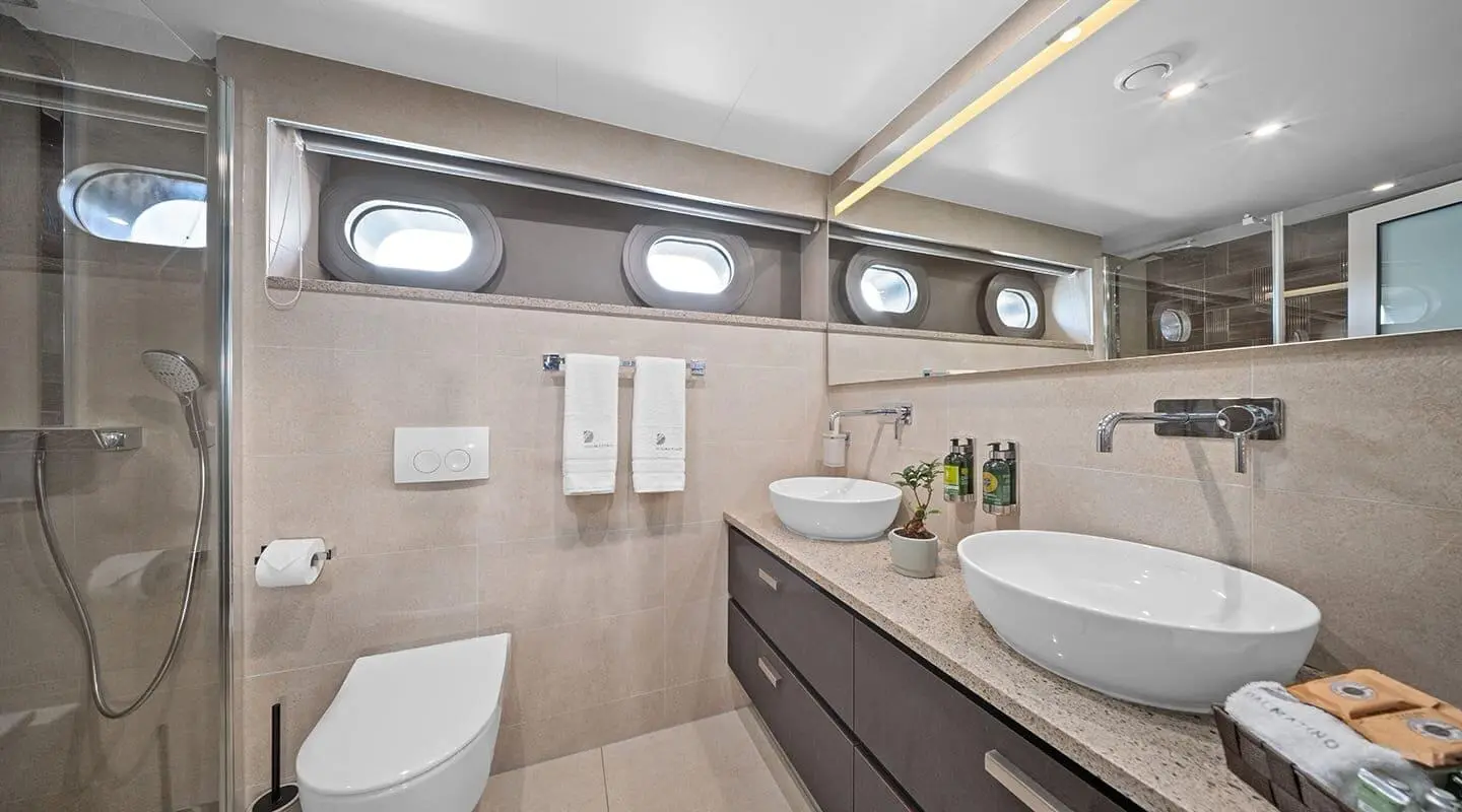 Interior of Dalmatino yacht with sink, mirrors, and seating area visible