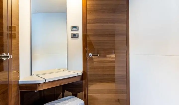 Aboard Vista cabin: wooden panel door, small seating area, porthole window, and built-in amenities visible