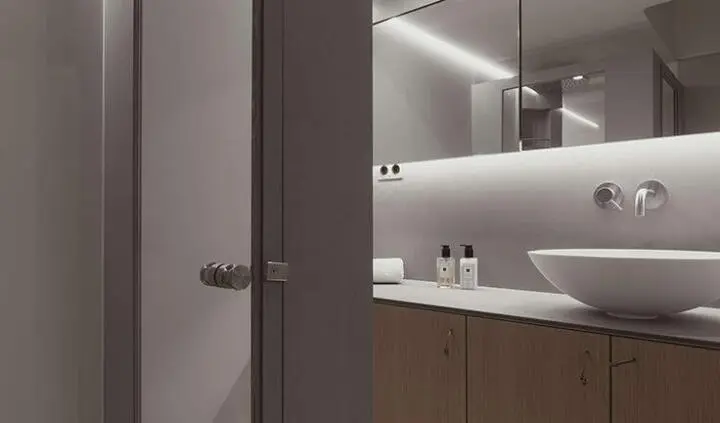 Nadamas yacht cabin interior with a modern vanity, vessel sink, and soft ambient lighting