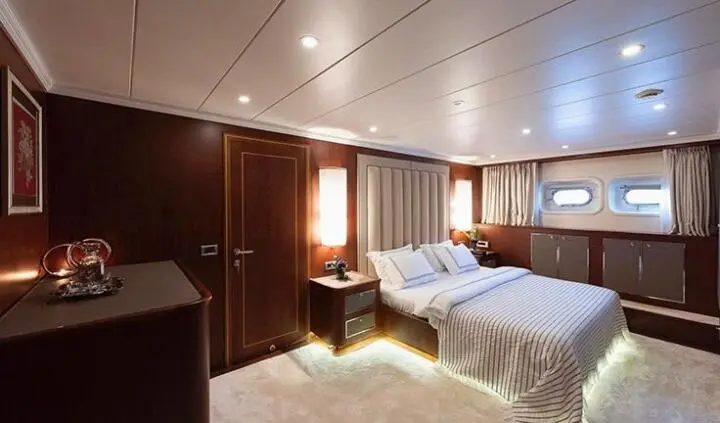 Ocean Breeze cabin interior with two neatly made beds and wooden paneling