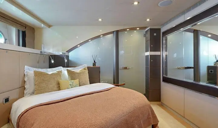 Master cabin with king bed, brown bedding, glass shower door, neutral decor