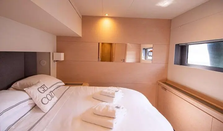 Master cabin with king bed and ensuite, soft lighting and wood panels
