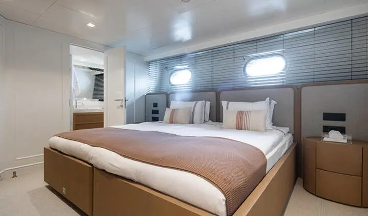Illusion II master cabin with king bed, built-in nightstands and windows