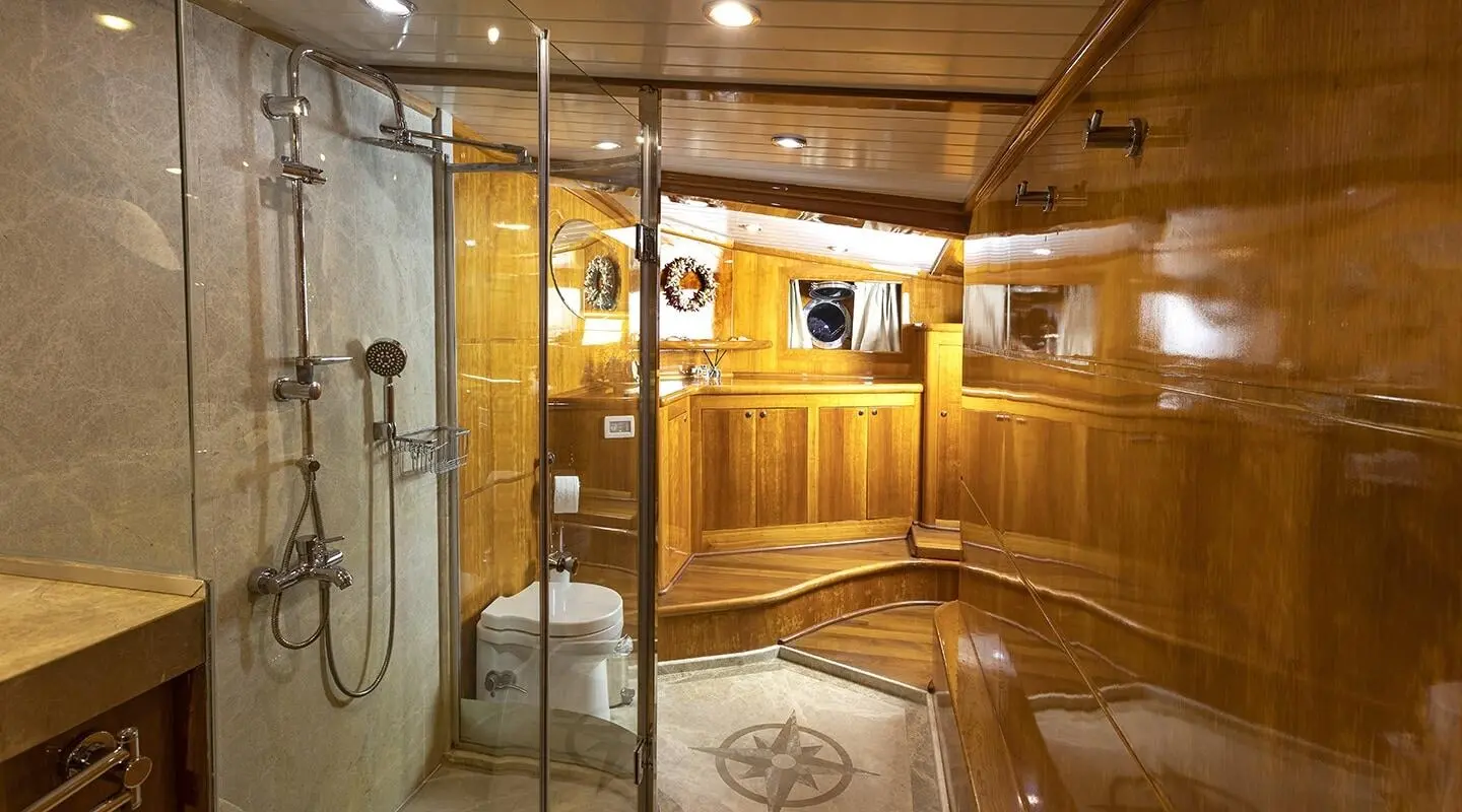 Elegant yacht interior with polished wood, ladder, and brass fixtures aboard
