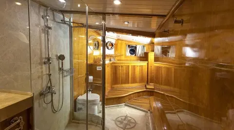 Elegant yacht interior with polished wood, ladder, and brass fixtures aboard